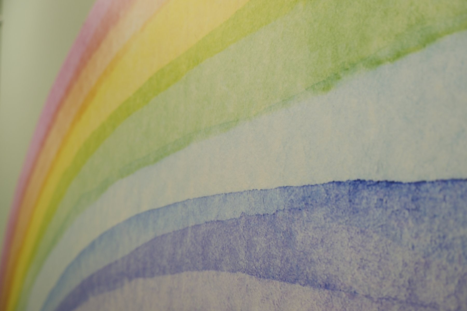 A watercolour rainbow painted on the wall at Lanes Vets